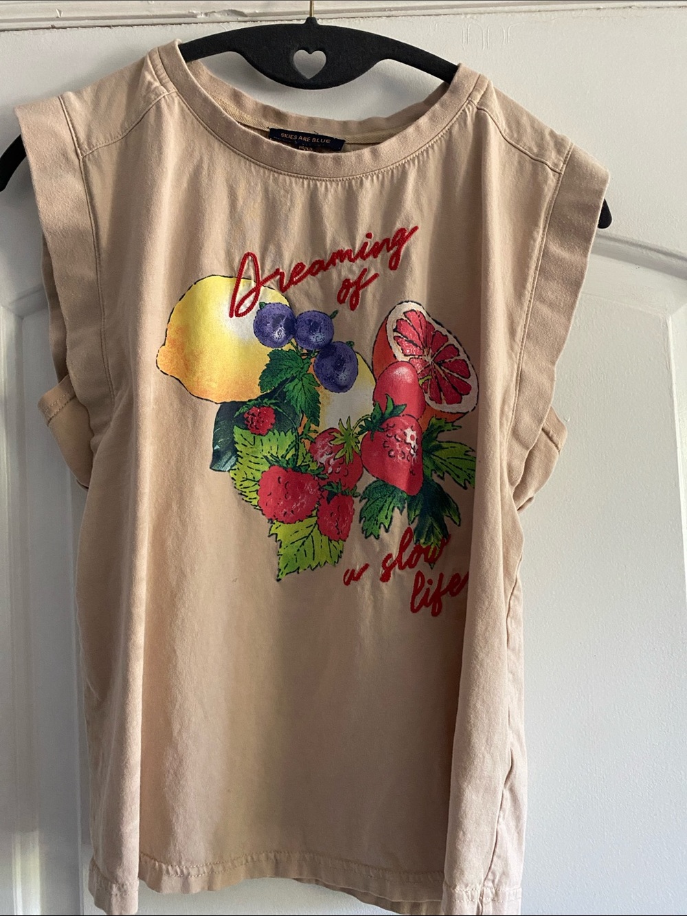 Skies Are Blue Cream Graphic Fruit Muscle Tee with Red Script